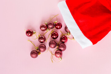 Christmas toys from santa claus hats on a pink background.