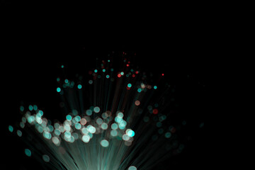 Fiber optic abstract neon lights colorful background. Close up view with bokeh. Glowing optical fibers. Abstract image with copy space.