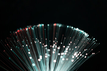 Fiber optic abstract neon lights colorful background. Close up view with bokeh. Glowing optical...
