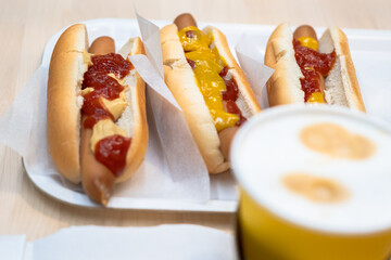 Fast food. Coffee in a cup and hot dog with ketchup and sauce