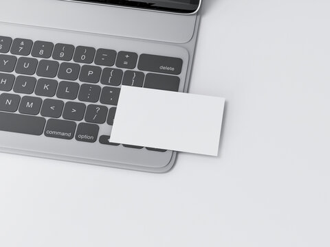 White Business Card Mockup on black digital tablet keyboard on concrete table