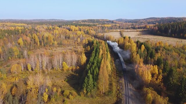Autumn landscape with historic steam train from Sortavala to Ruskeala. Karelia. Aerial view.