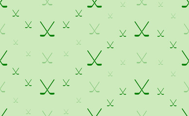 Seamless pattern of large and small green hockey symbols. The elements are arranged in a wavy. Vector illustration on light green background
