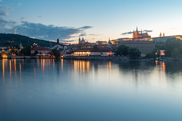 Vltava river and hill in old town of Prague at sunset time.