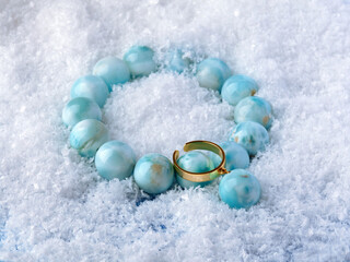 Luxury elegant blue larimar stone bracelet and pendant on white snow background