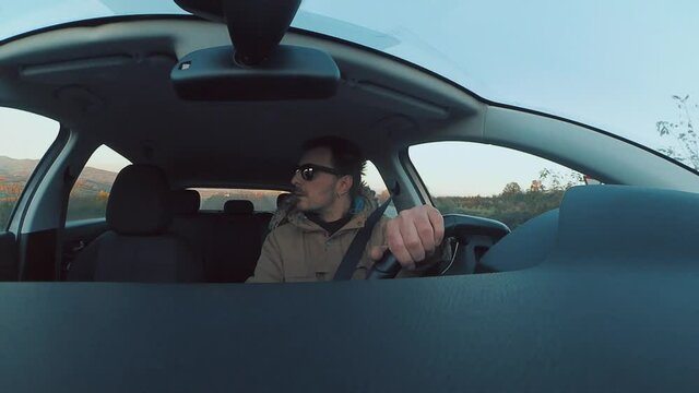 Attractive Young Man Reversing A Car