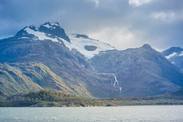 Waterfall view from the boat crossing Magallanes and the Chilean Antarctic Region, Chile.