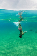 Little kid diving on the Mediterranean sea