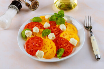 Salad made from tomato, mozzarella, basil and olive oil.
