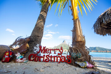 Merry Christmas sign with ornaments and other decorations on a warm, tropical island vacation