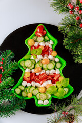 Tasty Christmas tree vegetable salad with decoration.