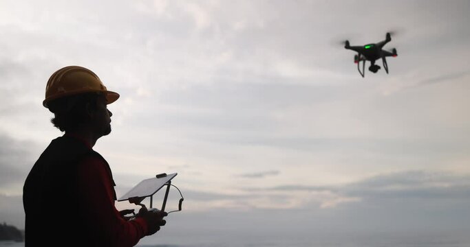 Man pilot engineer flying with drone - Video surveillance and industrial ispection concept