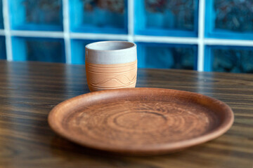 Clay plate and mug on wooden table