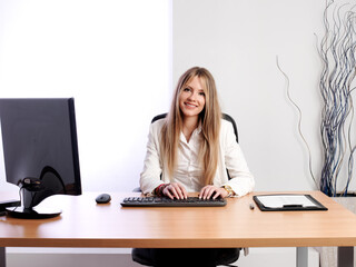 Young business woman smiling and with positive attitude