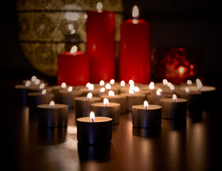 Many burning tealight candles stock images. Christmas still life with candles stock photo. Romantic still life with red candles stock images. Beautiful christmas candles stock images