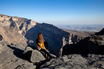 Woman admiring the Jebel Shams canyon in Oman