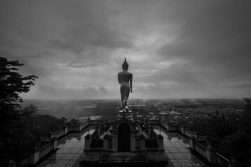 Fototapeta na wymiar Buddha statue standing on a mountain Wat Phra That Khao Noi, Nan Province, Thailand