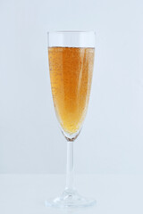 Glass of sparkling champagne on a white background.