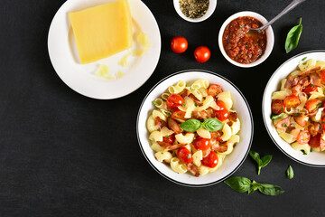 Pasta with bacon, tomato, parmesan cheese and basil leaves