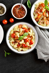 Pasta with bacon, tomato, parmesan cheese and basil leaves