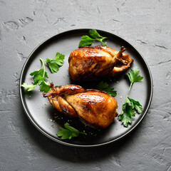 Roasted quails on plate