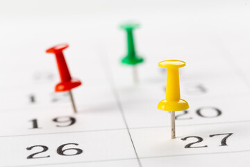 Push pins on calendar. Idea concept of to do planning.
