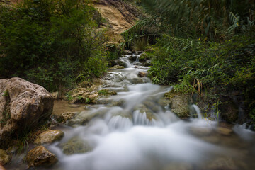Obraz premium River water flows among the rocks and forms small waterfalls, Bullas, Murcia, Spain