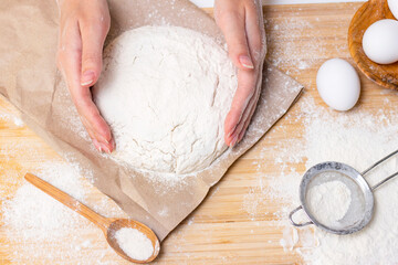 Female hands making pizza dough