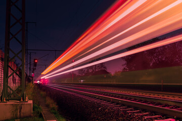 Fototapeta na wymiar Light trails from a train, railroad tracks at night, Light Trails, Train, abstract, colorful
