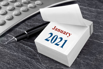 Desk with calendar and calculator January 2021