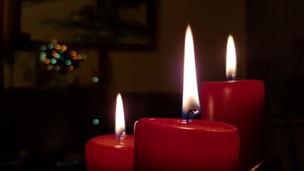 Closeup of red candles flaming in night