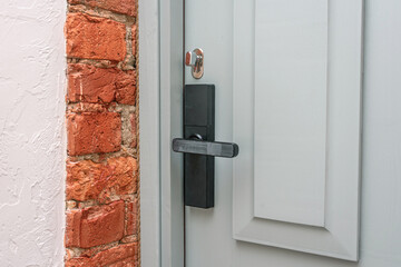 White door to the house, door handle, close up