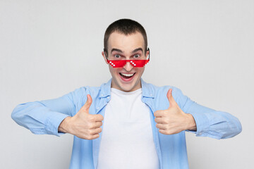Film fan in red pixels glasses showing thumbs up, portrait, white background