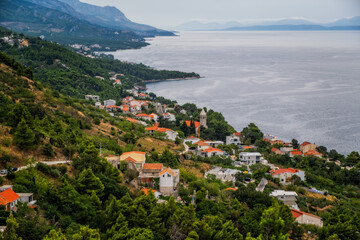 Looking down to the town of Brela on the Adriatic coastline of Croatia. Cloudy august day, 2020