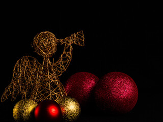 ANGEL ANNOUNCER ON BLACK BACKGROUND WITH CHRISTMAS BALLS