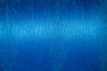 Blue thread texture. Close-up of the thread wound on a spool.