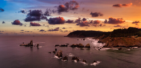 Obraz na płótnie Canvas Cannon Beach, Oregon, United States. Beautiful Aerial Panoramic View of the Rocky Pacific Ocean Coast. Dramatic Cloudy Sunrise Sky.