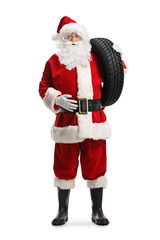 Full length portrait of santa claus carrying a car tire on his shoulder