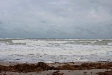 Foamy beach waves against the sand