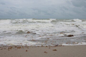 Foamy beach waves against the sand