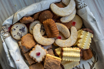 Group of delicious sweet Christmas cookies, white vanilla rolls, gingerbread, linzer and chocolate sweets wiht jam filling
