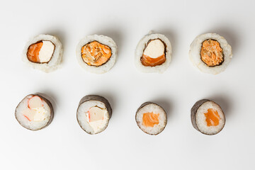 Top view of fresh sushi rolls on white background