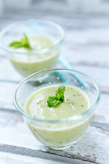 Green smoothie topped with chia seeds on bright wooden background. Close up.	