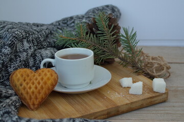
a cup of tea and heart cookies