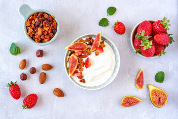 Greek yogurt with granola ,strawberry and fig in the bowl . Top view with copy space