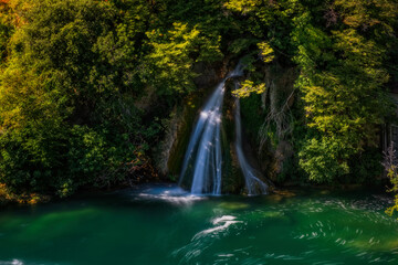 Waterfall and clear river water. Near the source of the Krka River in Croatia. Long exposure, september 2020