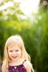 Little Girl with Blond Hair Enjoying a Summer Day Outside, Childhood Lifestyle Portrait
