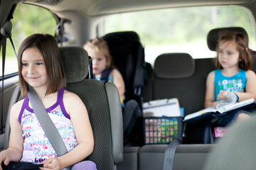 Three Little Girls Sitting in a Minivan - obrazy, fototapety, plakaty