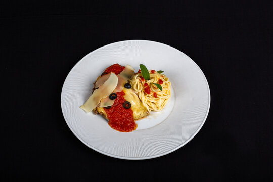 Italian plasta on plate with cheese and sauce