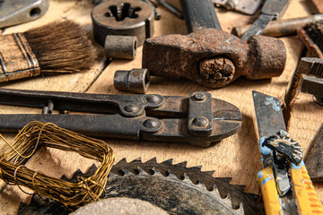 Old vintage household hand tools still life on a wooden background in a DIY and repair concept